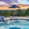 umbrella shaded table and chairs next to pool